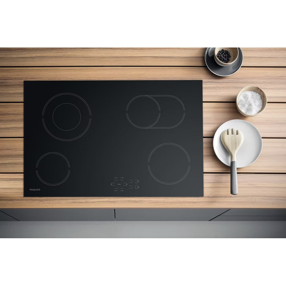 Hotpoint HR724CH 77cm black ceramic hob with double ring zones and touch control, ideal for sleek modern kitchens.