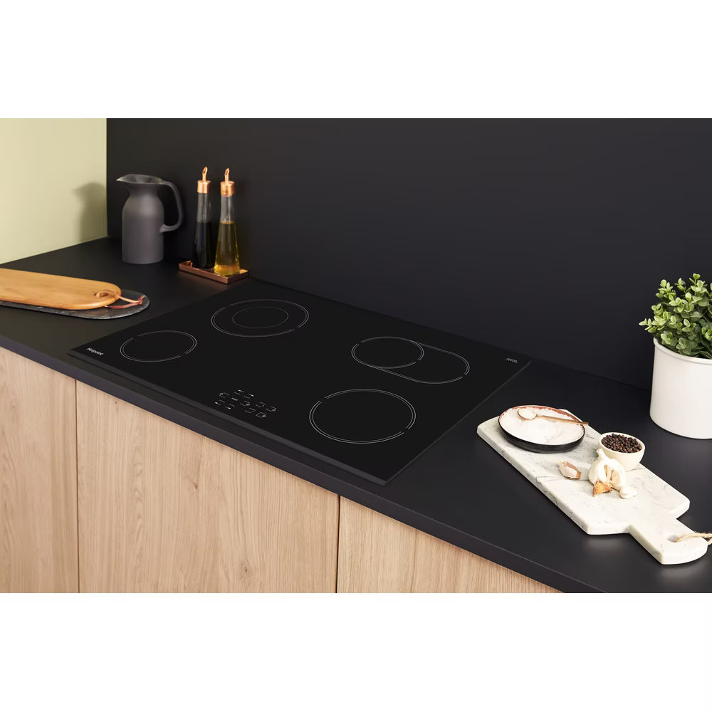 Hotpoint HR724CH black ceramic hob with double ring zone and touch control, sleek electric cooking surface.